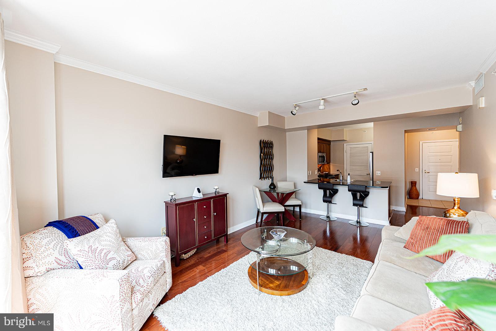 631 D Street Northwest, Unit 1231 Washington, DC 20004 - Photo 47 of 48 a living room with furniture and a flat screen tv