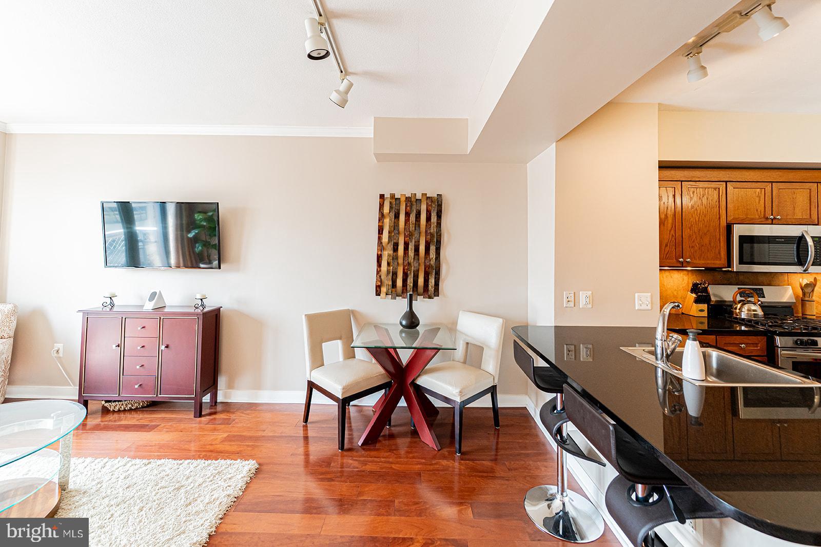 631 D Street Northwest, Unit 1231 Washington, DC 20004 - Photo 6 of 48 a view of a livingroom with furniture and workspace