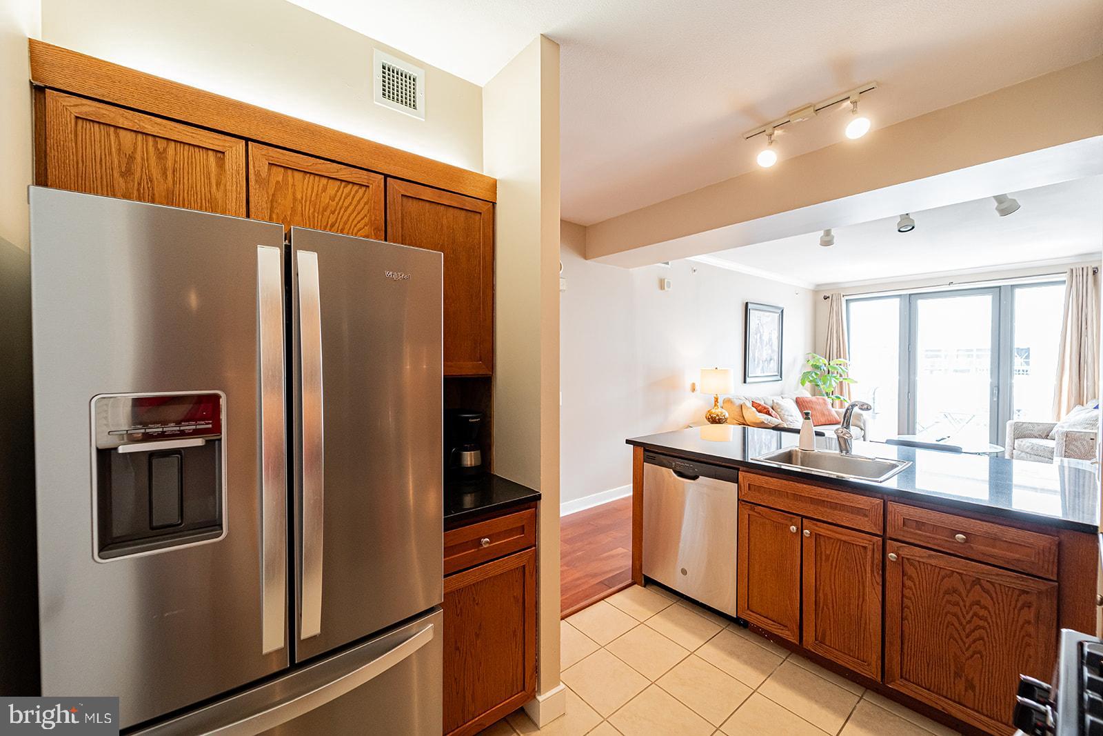 631 D Street Northwest, Unit 1231 Washington, DC 20004 - Photo 7 of 48 a kitchen with stainless steel appliances granite countertop a refrigerator and a sink