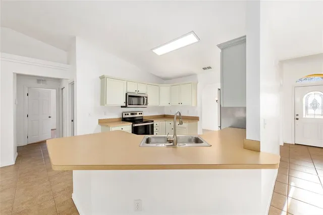 a kitchen with stainless steel appliances granite countertop a stove and a refrigerator