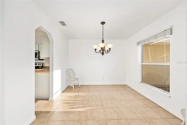 a view of a chandelier in big room and chandelier