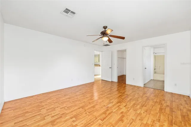 a view of workspace with wooden floor and ceiling fan