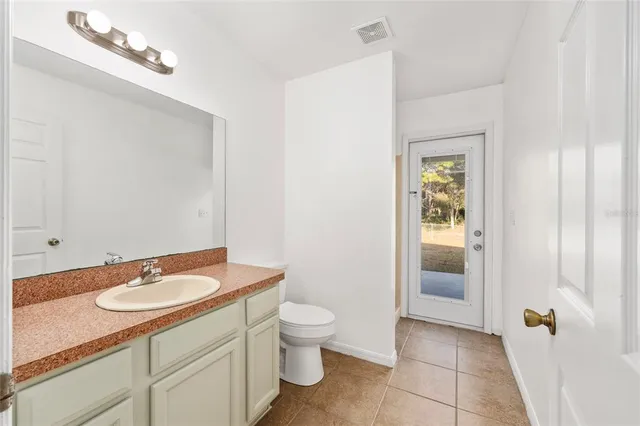a bathroom with a glass door and a shower