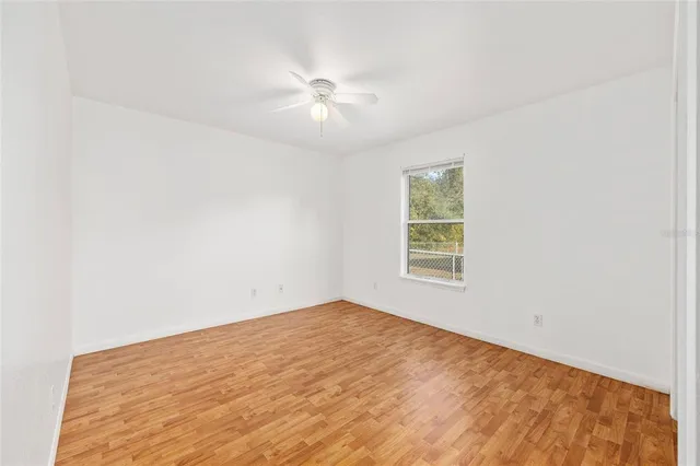 a view of empty room with ceiling fan