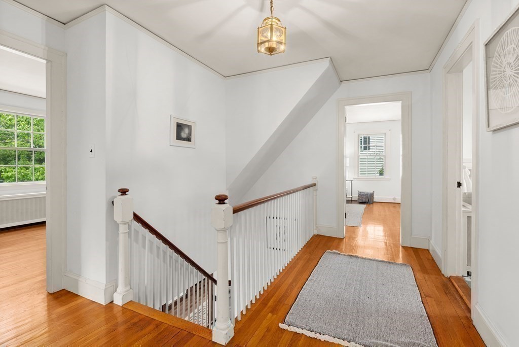 70 Edgemoor Road Belmont, MA 02478 - Photo 11 of 24 a view of a hallway with wooden floor and staircase