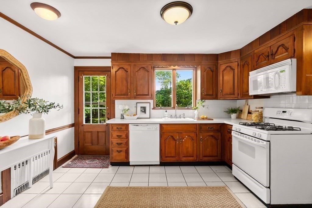 70 Edgemoor Road Belmont, MA 02478 - Photo 8 of 24 a large kitchen with stainless steel appliances granite countertop a stove a sink and a microwave