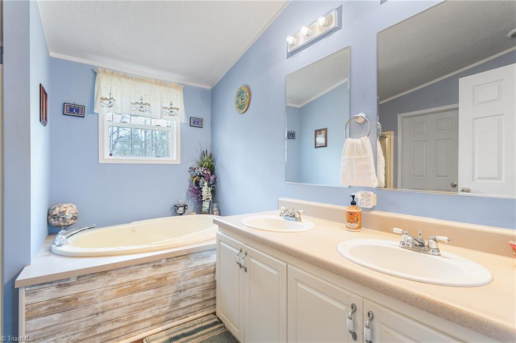 8734 Fulp Road Stokesdale, NC 27357 - Photo 20 of 28 Ensuite primary bathroom