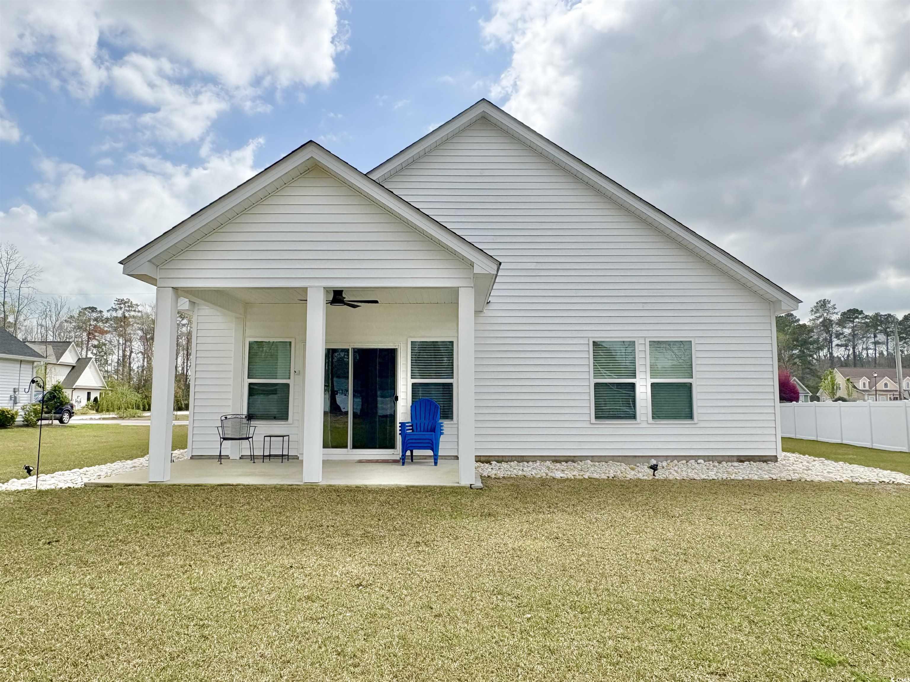 11124 Lee Circle Murrells Inlet, SC 29576 - Photo 24 of 25 Back of house with fence, a yard, a patio area, an