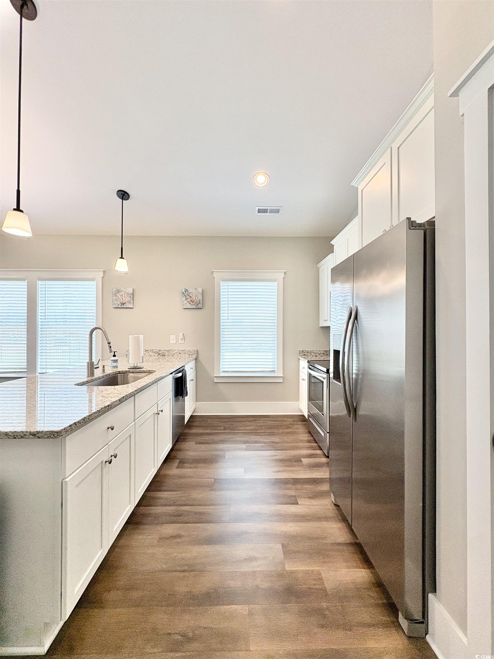 11124 Lee Circle Murrells Inlet, SC 29576 - Photo 3 of 25 Kitchen with a peninsula, white cabinets, visible