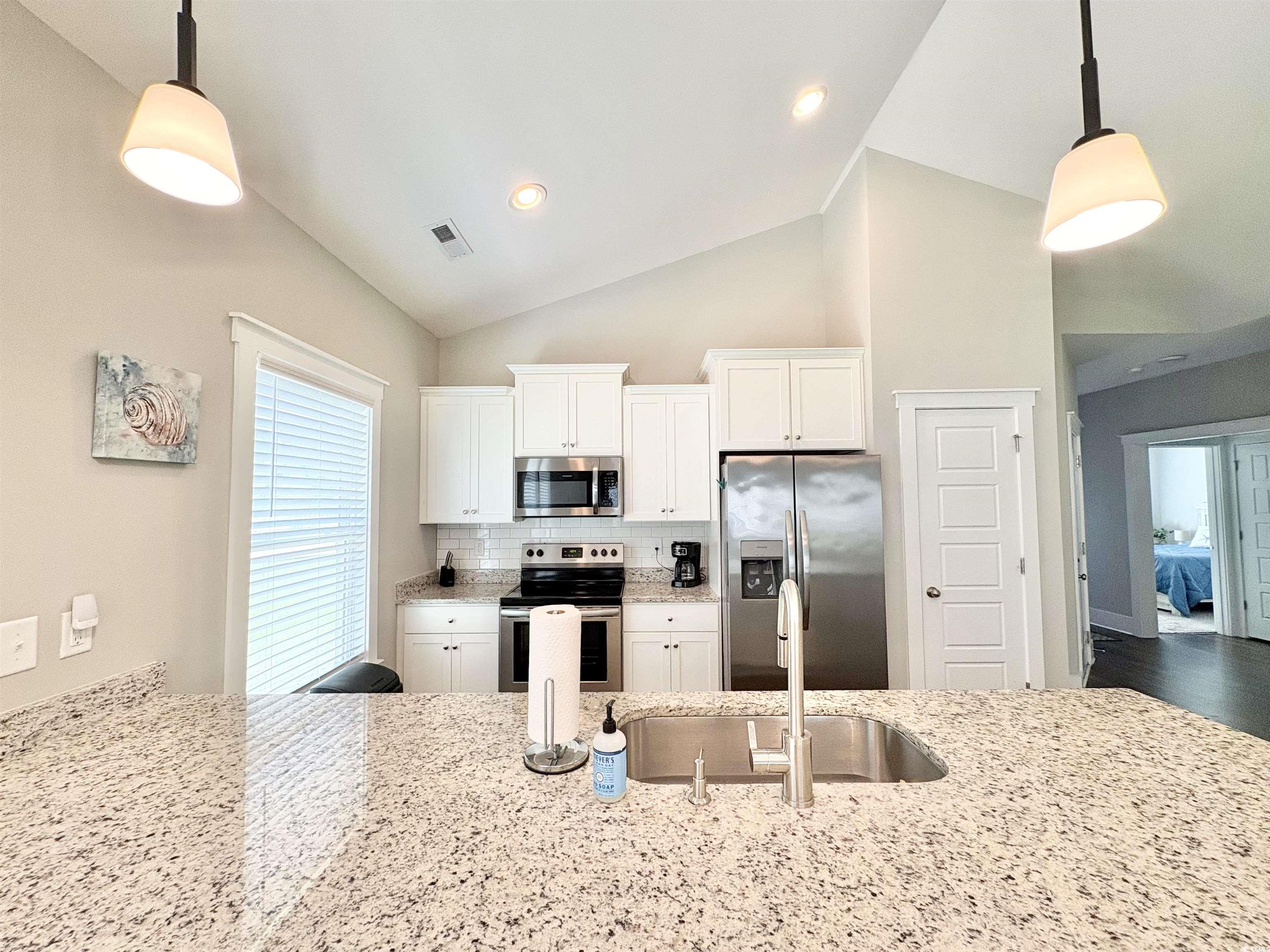 11124 Lee Circle Murrells Inlet, SC 29576 - Photo 5 of 25 Kitchen with tasteful backsplash, visible vents, a