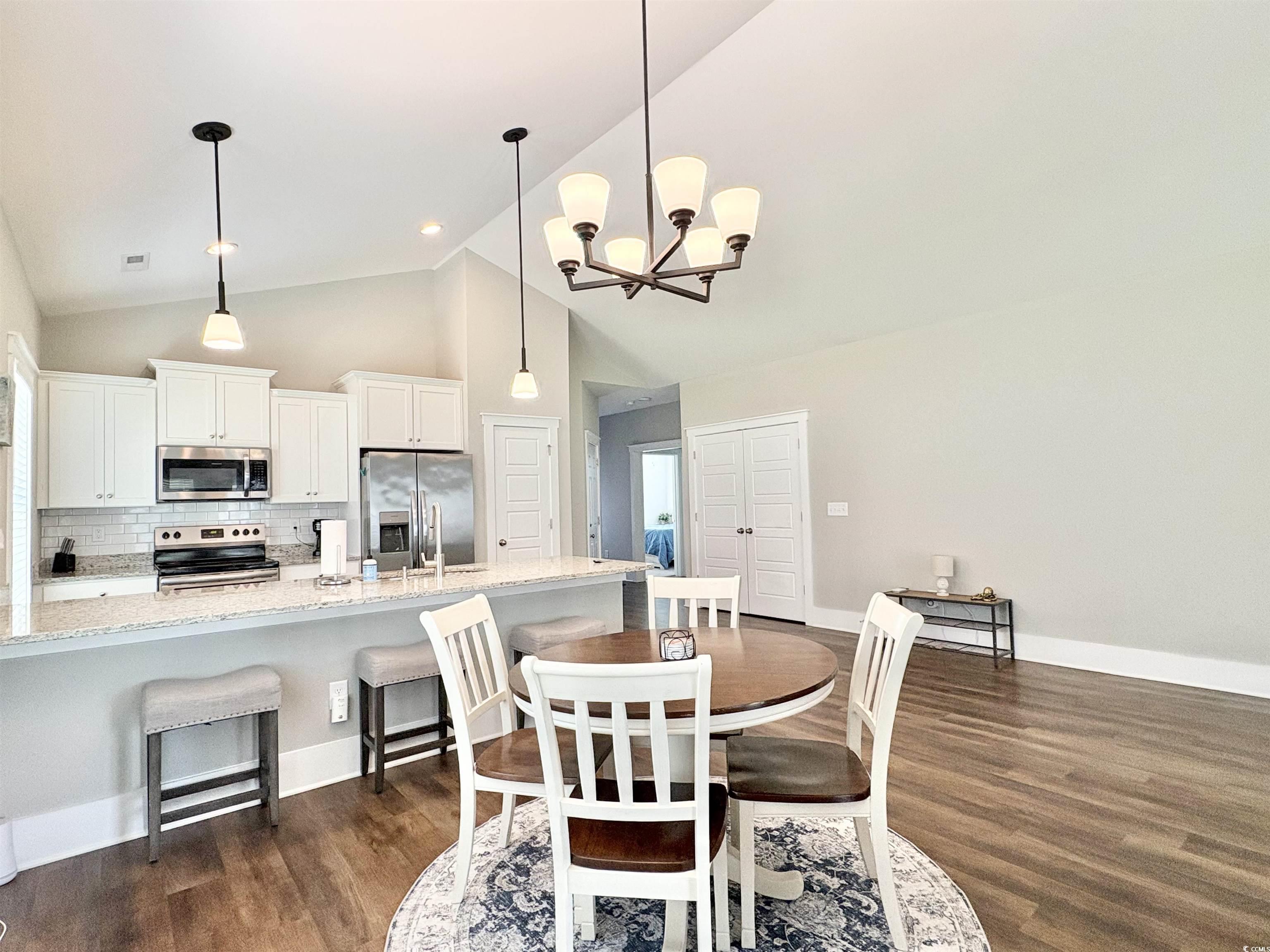 11124 Lee Circle Murrells Inlet, SC 29576 - Photo 6 of 25 Dining space with high vaulted ceiling, dark wood-
