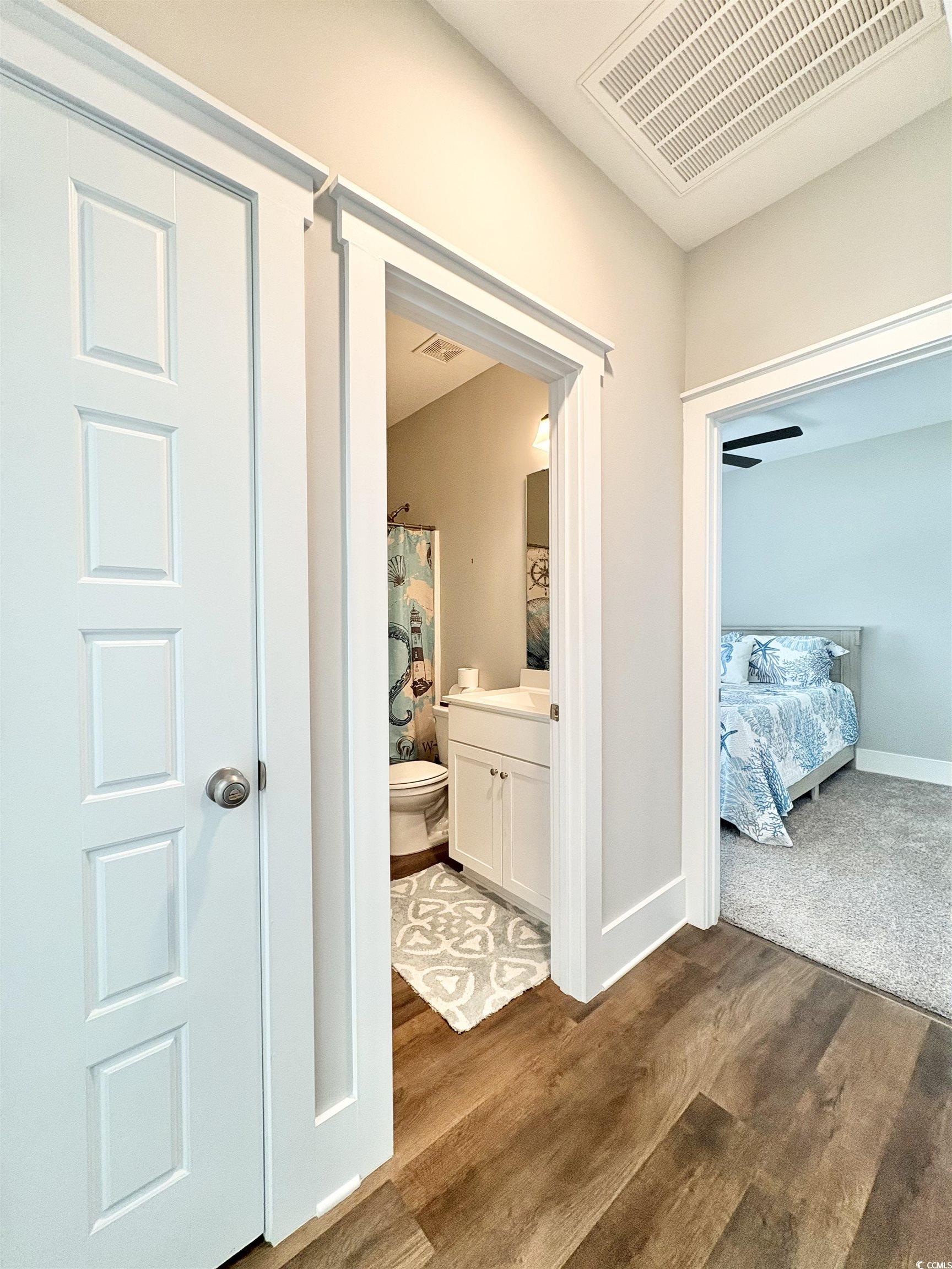 11124 Lee Circle Murrells Inlet, SC 29576 - Photo 9 of 25 Hallway with dark wood-type flooring, visible vent