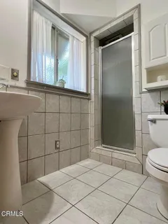a bathroom with a toilet and a shower