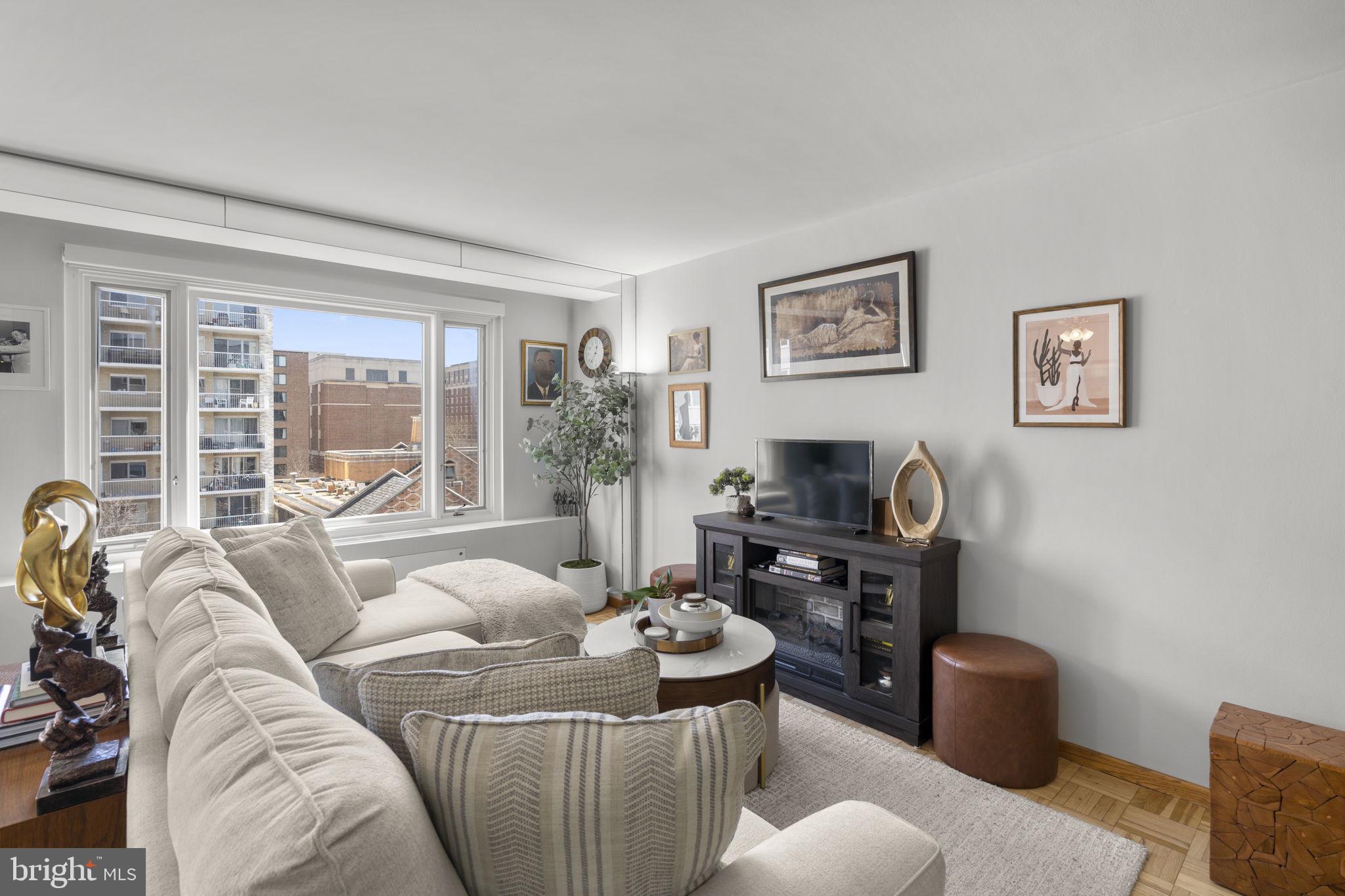 2475 Virginia Avenue Northwest, Unit 620 Washington, DC 20037 - Photo 12 of 30 a living room with furniture and a floor to ceiling window