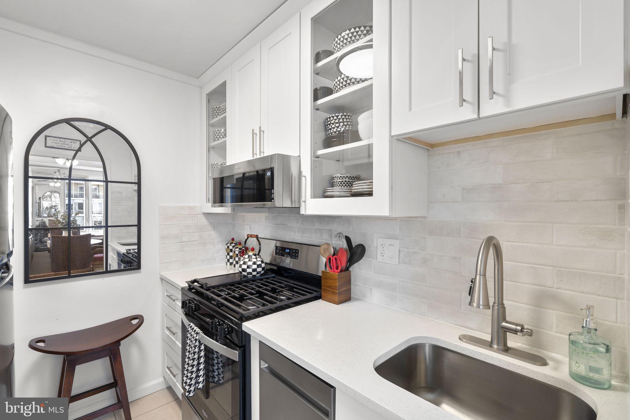 2475 Virginia Avenue Northwest, Unit 620 Washington, DC 20037 - Photo 21 of 30 a kitchen with stainless steel appliances granite countertop a sink and cabinets