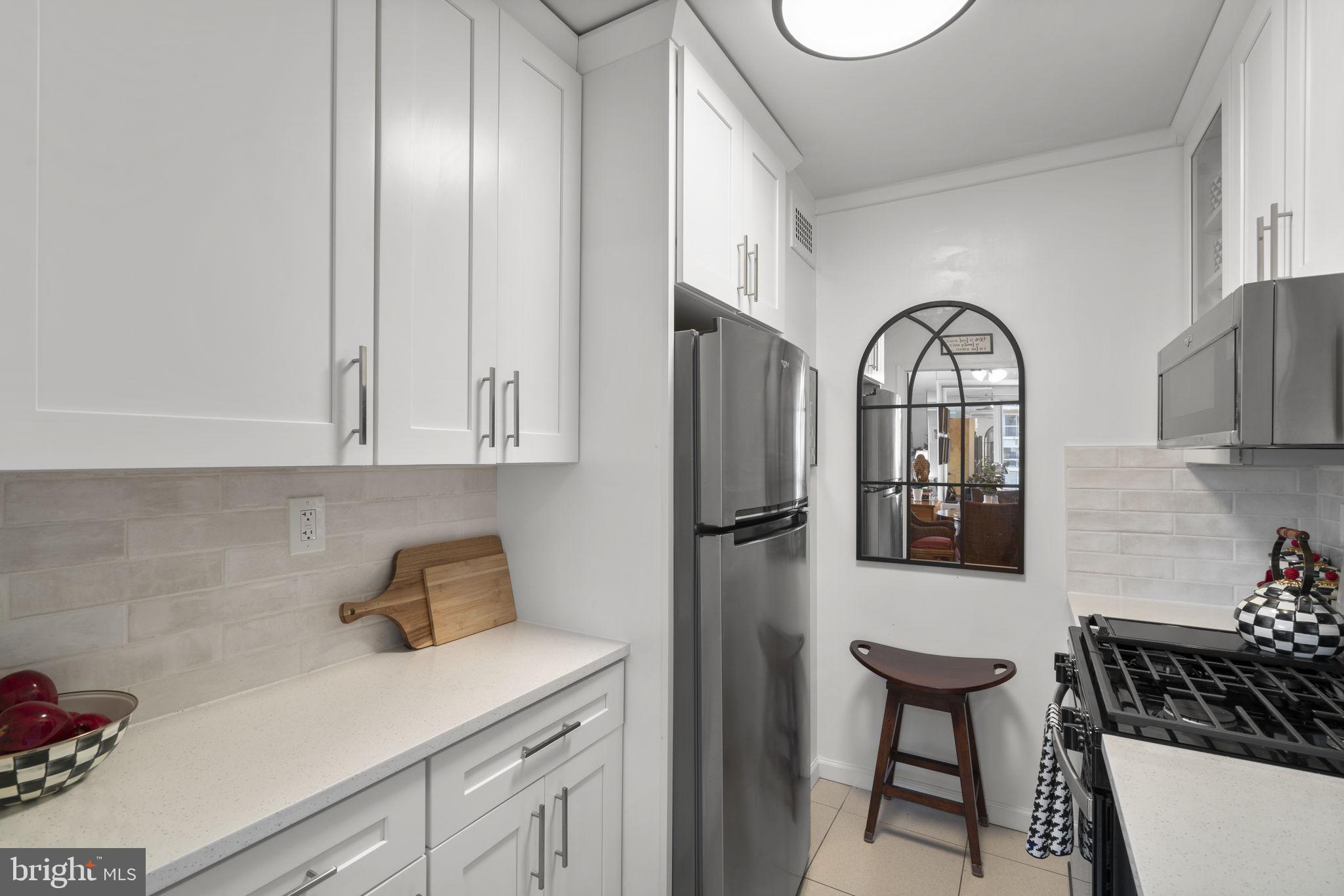 2475 Virginia Avenue Northwest, Unit 620 Washington, DC 20037 - Photo 22 of 30 a kitchen with stainless steel appliances granite countertop a refrigerator sink and cabinets