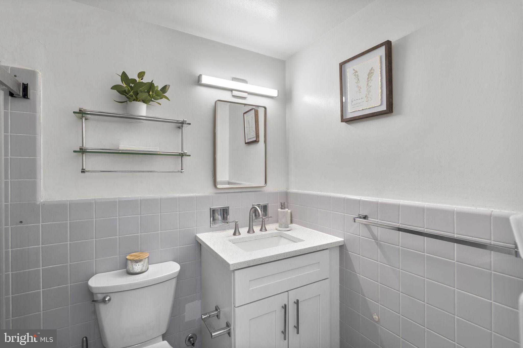 2475 Virginia Avenue Northwest, Unit 620 Washington, DC 20037 - Photo 28 of 30 a bathroom with a sink toilet and a mirror
