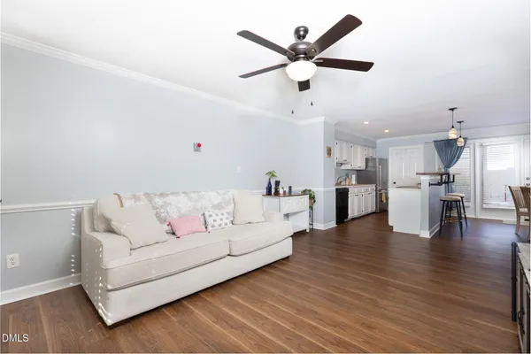 a living room with furniture and kitchen view