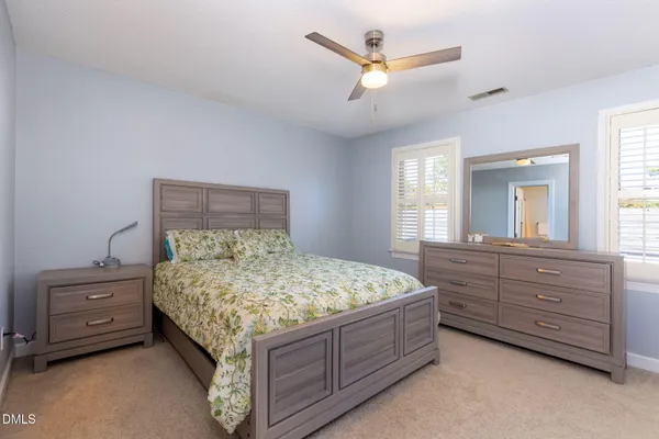 a bed room with a bed and a dresser