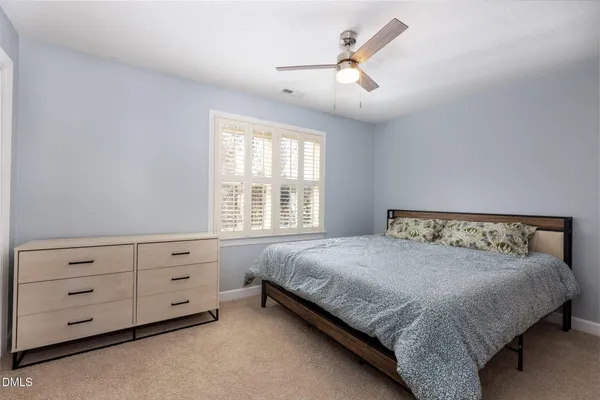 a bedroom with a bed a window and closet