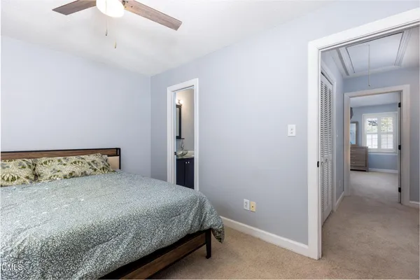 a bedroom with a bed and a mirror
