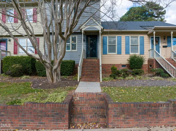 front view of a brick house with a yard