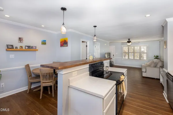 a kitchen that has a table chairs and a wooden floor