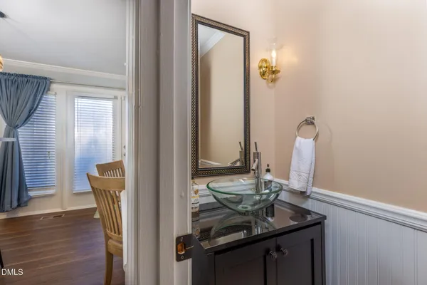 a view of bathroom with a sink and mirror