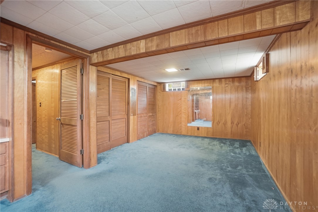 6119 Flemington Road Dayton, OH 45459 - Photo 43 of 76 This versatile room offers abundant storage with wood paneled walls and comfortable carpeting.
