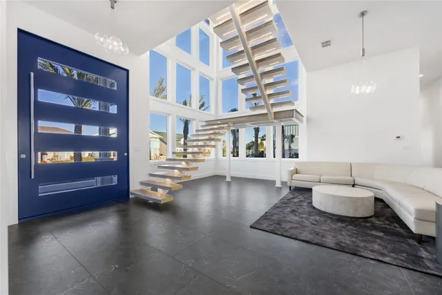 a view of a kitchen with kitchen island granite countertop a large counter top stainless steel appliances and cabinets