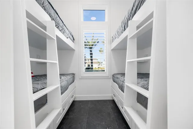 a kitchen with granite countertop a sink and dishwasher a stove with wooden floor