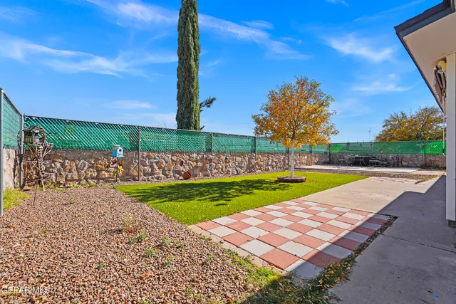 a living room with furniture a flat screen tv and a window