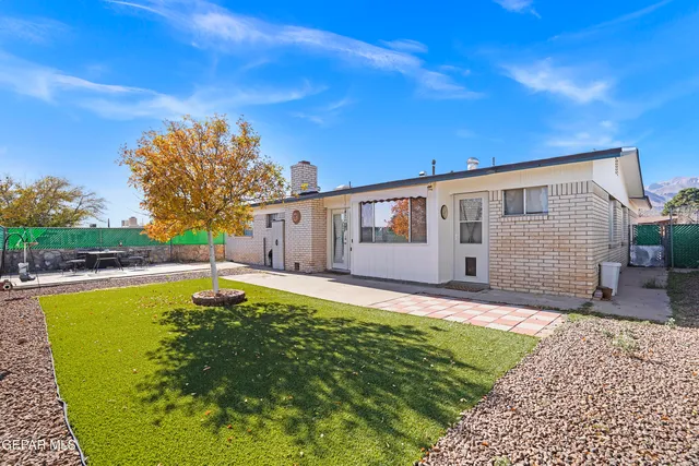 a living room with furniture a flat screen tv and a lamp