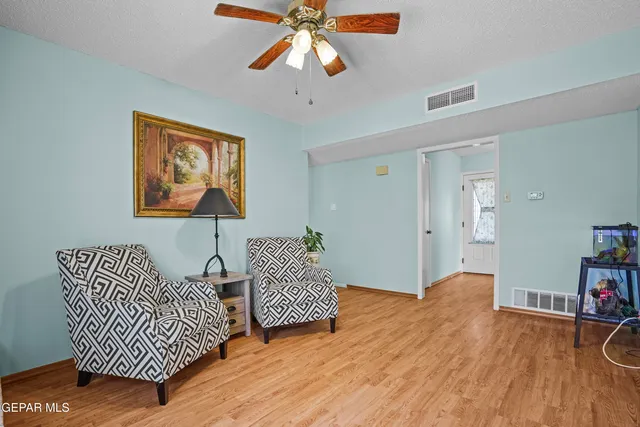 a view of a room with wooden floor and entryway