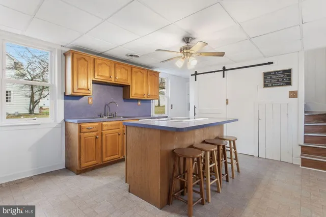 a kitchen with stainless steel appliances granite countertop a sink and a refrigerator