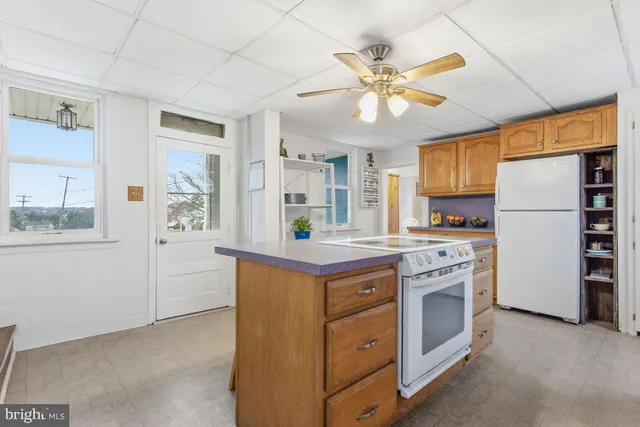 a kitchen with stainless steel appliances granite countertop a stove and a refrigerator