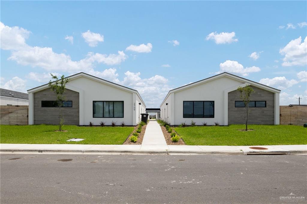 a view of front a house with a yard and garage