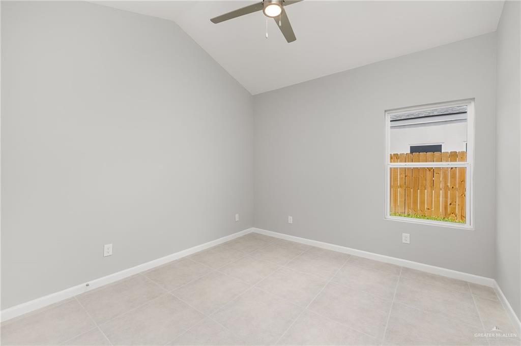 2701 Robin Road Weslaco, TX 78596 - Photo 12 of 30 an empty room with a window and ceiling fan