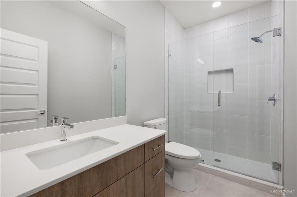 2701 Robin Road Weslaco, TX 78596 - Photo 25 of 30 a bathroom with a sink a toilet and shower