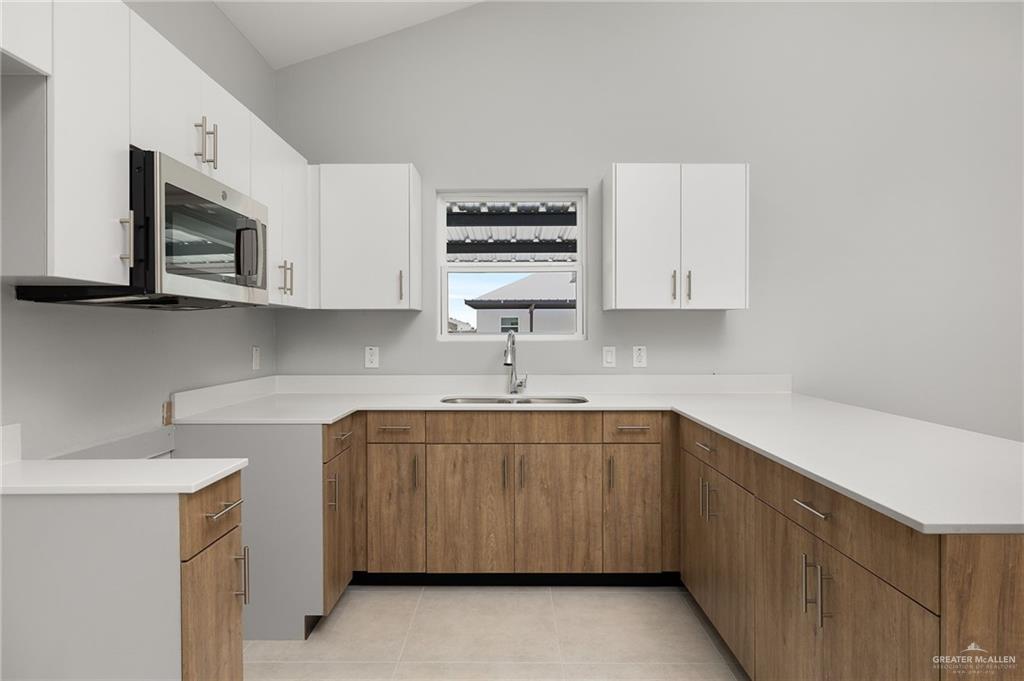 2701 Robin Road Weslaco, TX 78596 - Photo 8 of 30 a kitchen with stainless steel appliances granite countertop a sink and a microwave