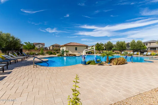 a view of a swimming pool with an outdoor seating