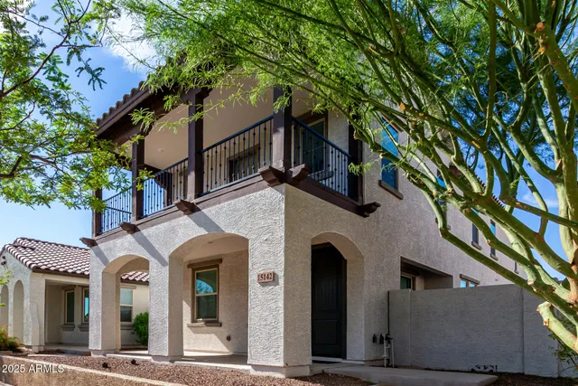 a view of a white house with large tree