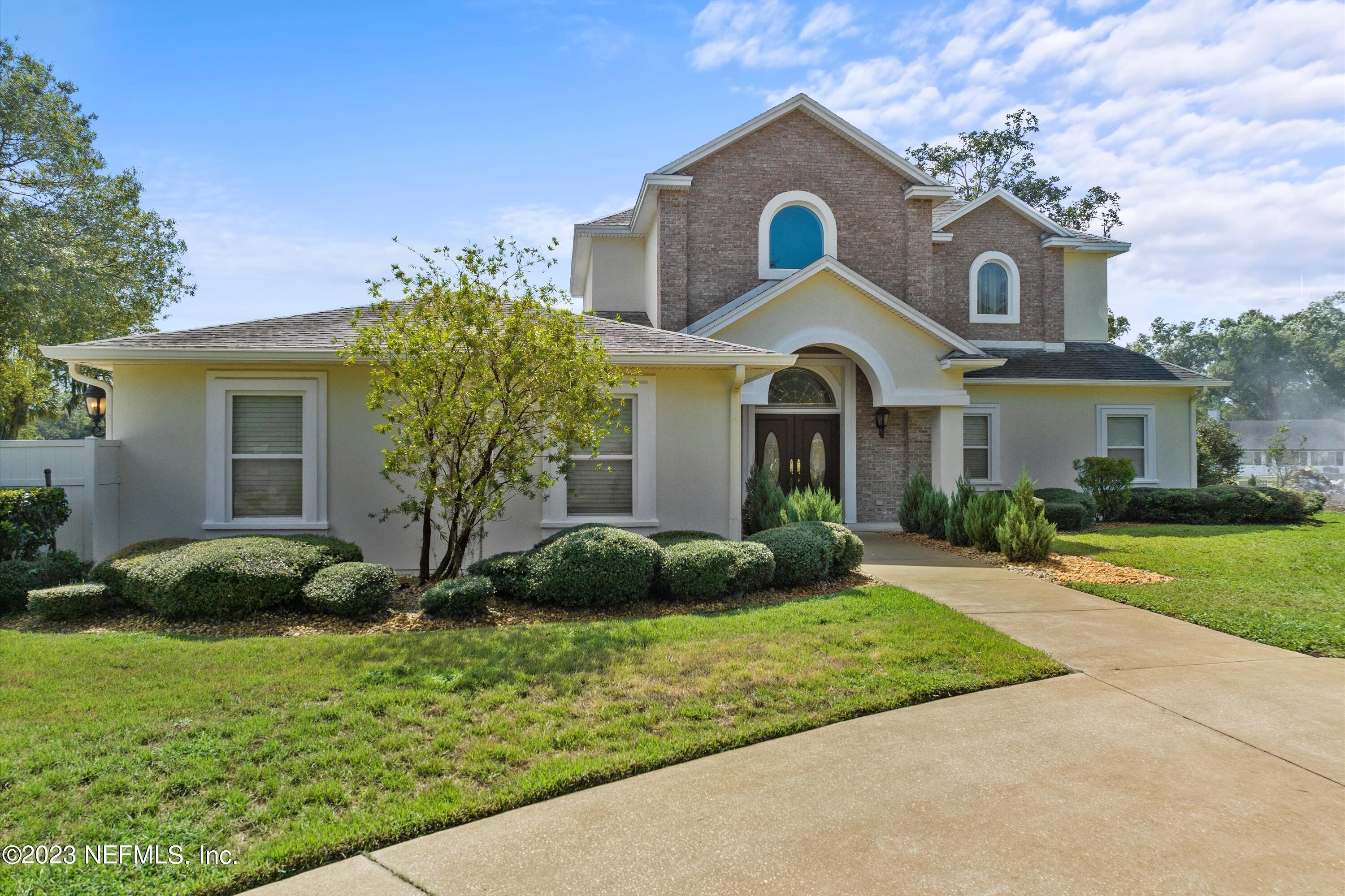 7936 Pine Lake Road Jacksonville, FL 32256 - Photo 1 of 52 a front view of a house with garden
