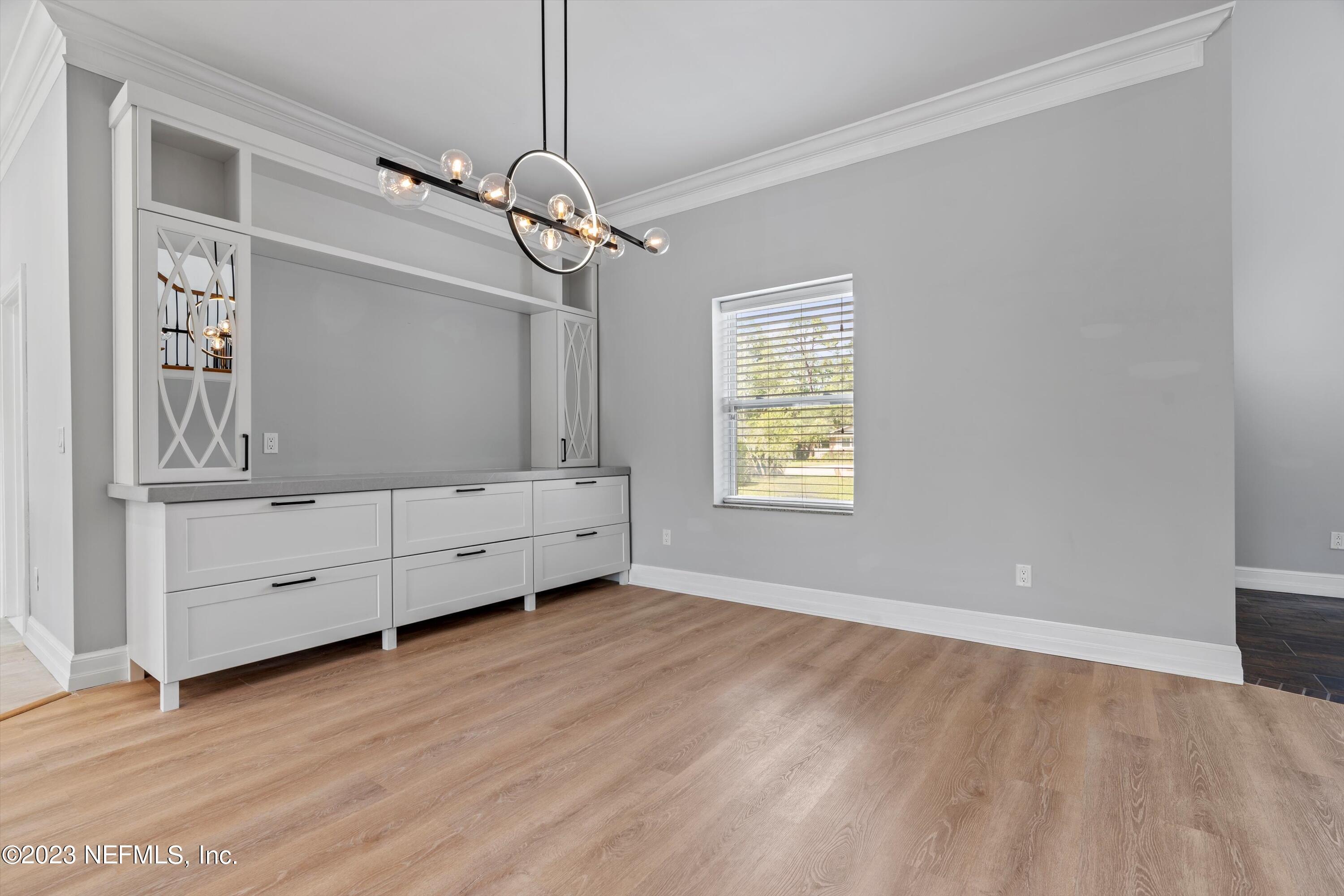 7936 Pine Lake Road Jacksonville, FL 32256 - Photo 12 of 52 an empty room with windows and cabinet