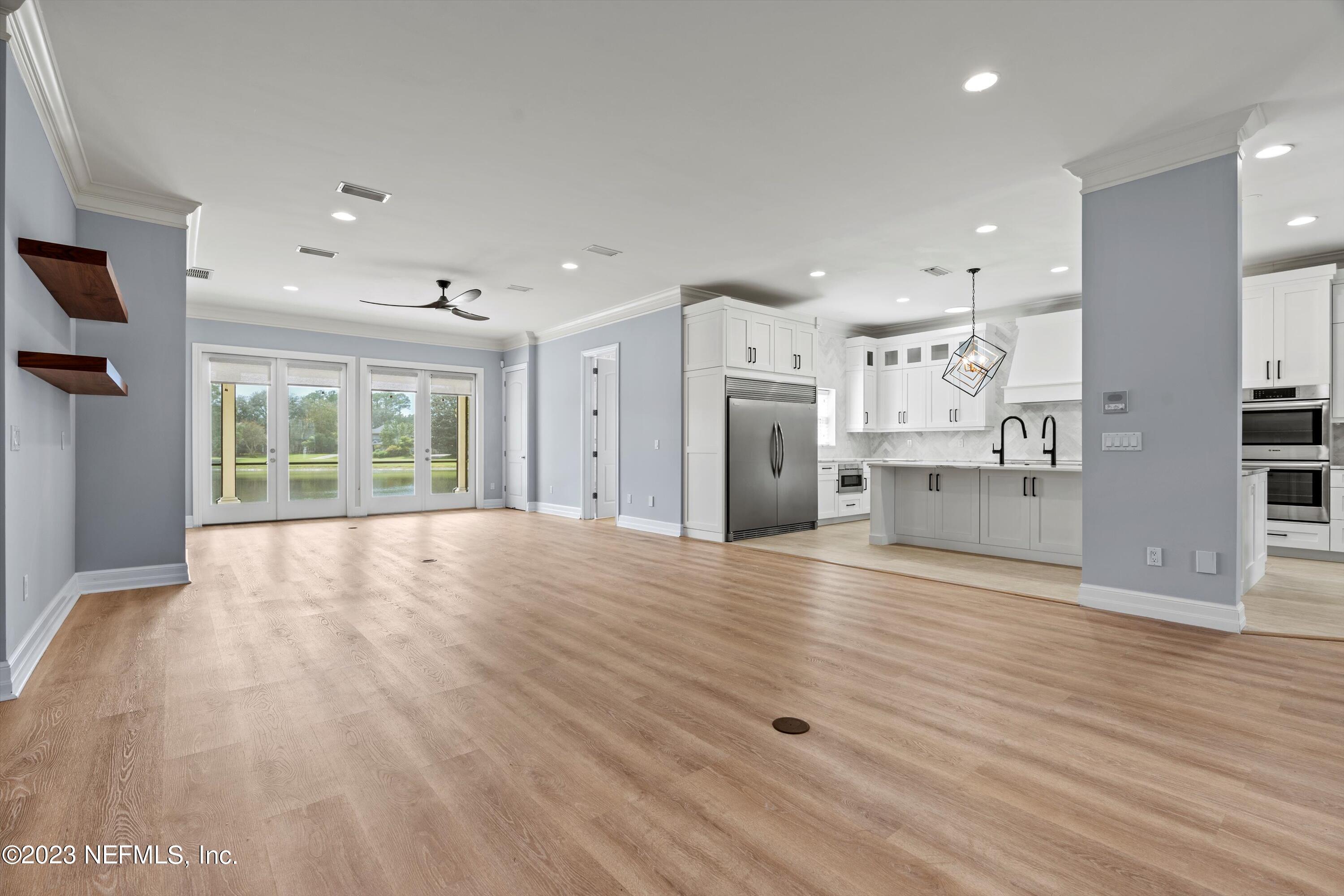 7936 Pine Lake Road Jacksonville, FL 32256 - Photo 13 of 52 a view of a kitchen with refrigerator and wooden floor