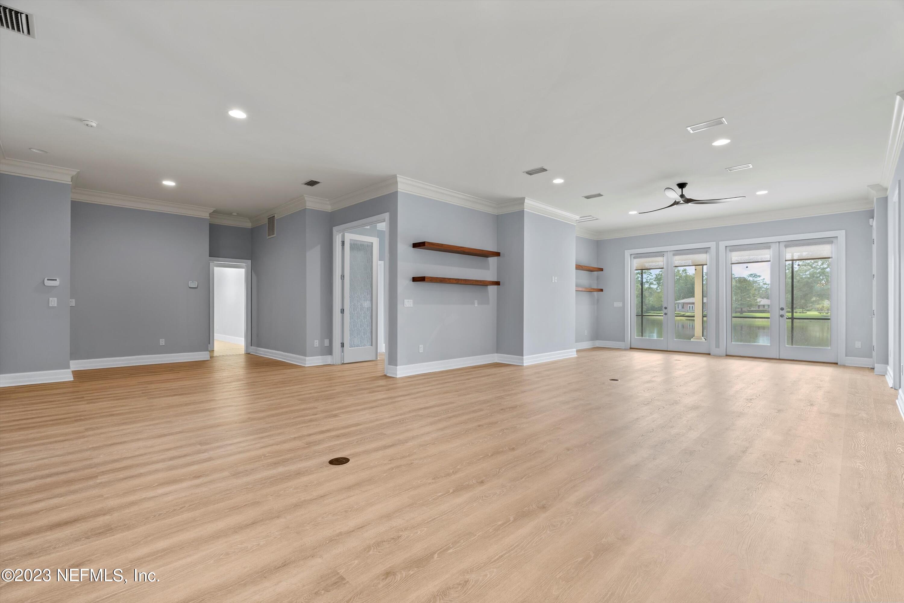 7936 Pine Lake Road Jacksonville, FL 32256 - Photo 14 of 52 a view of an empty room with wooden floor and windows