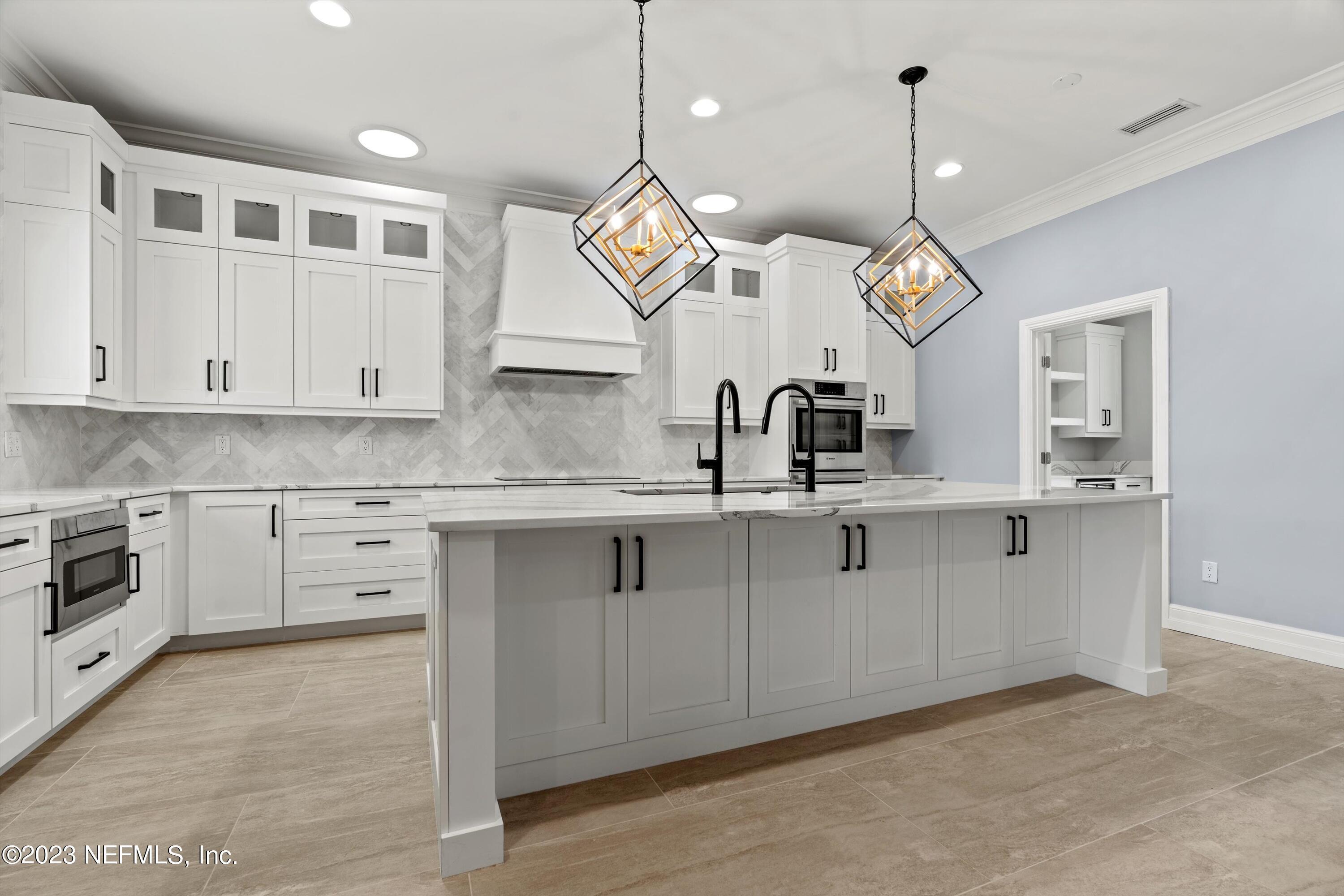 7936 Pine Lake Road Jacksonville, FL 32256 - Photo 16 of 52 a kitchen with white cabinets and sink