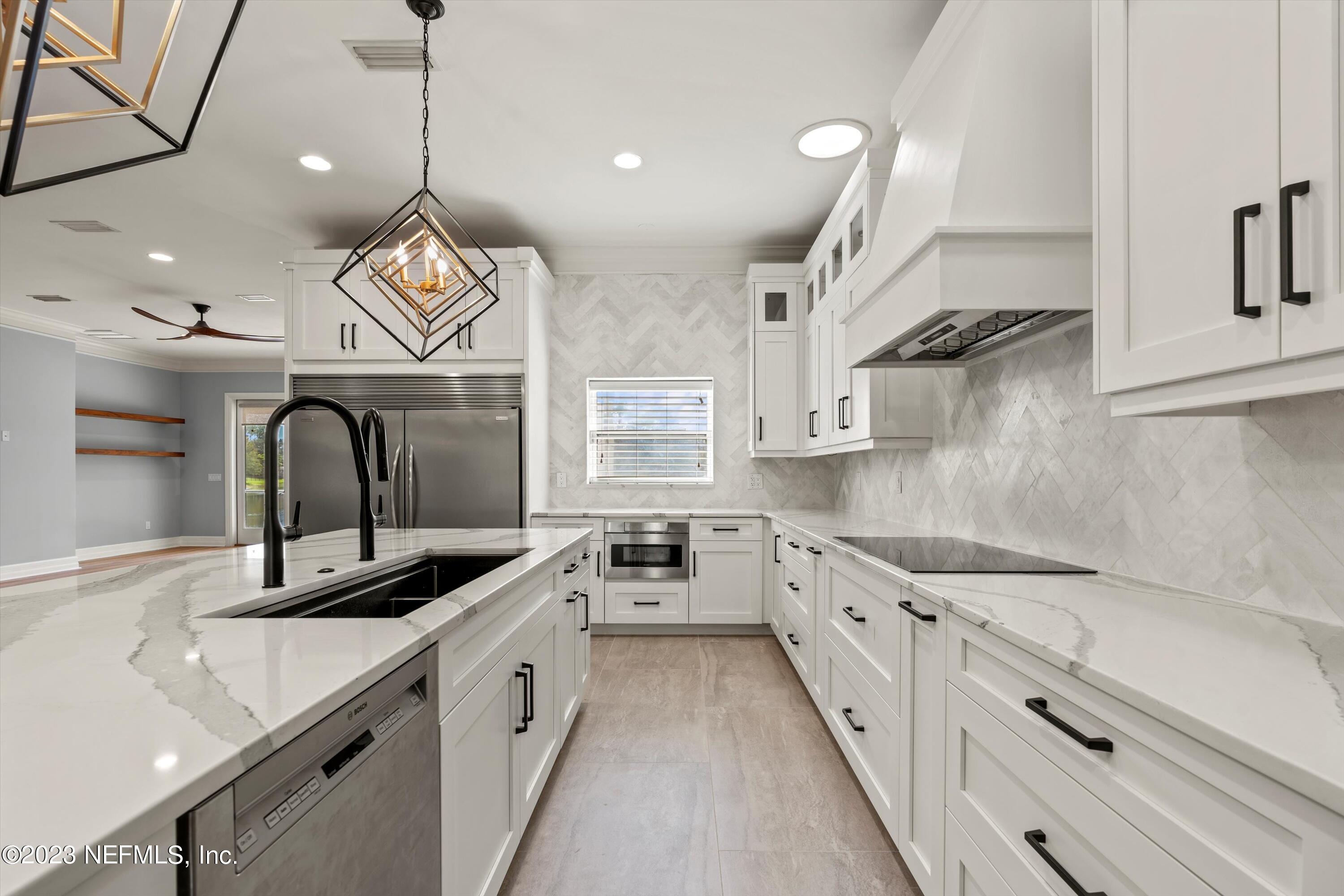7936 Pine Lake Road Jacksonville, FL 32256 - Photo 18 of 52 a large kitchen with stainless steel appliances and white cabinets