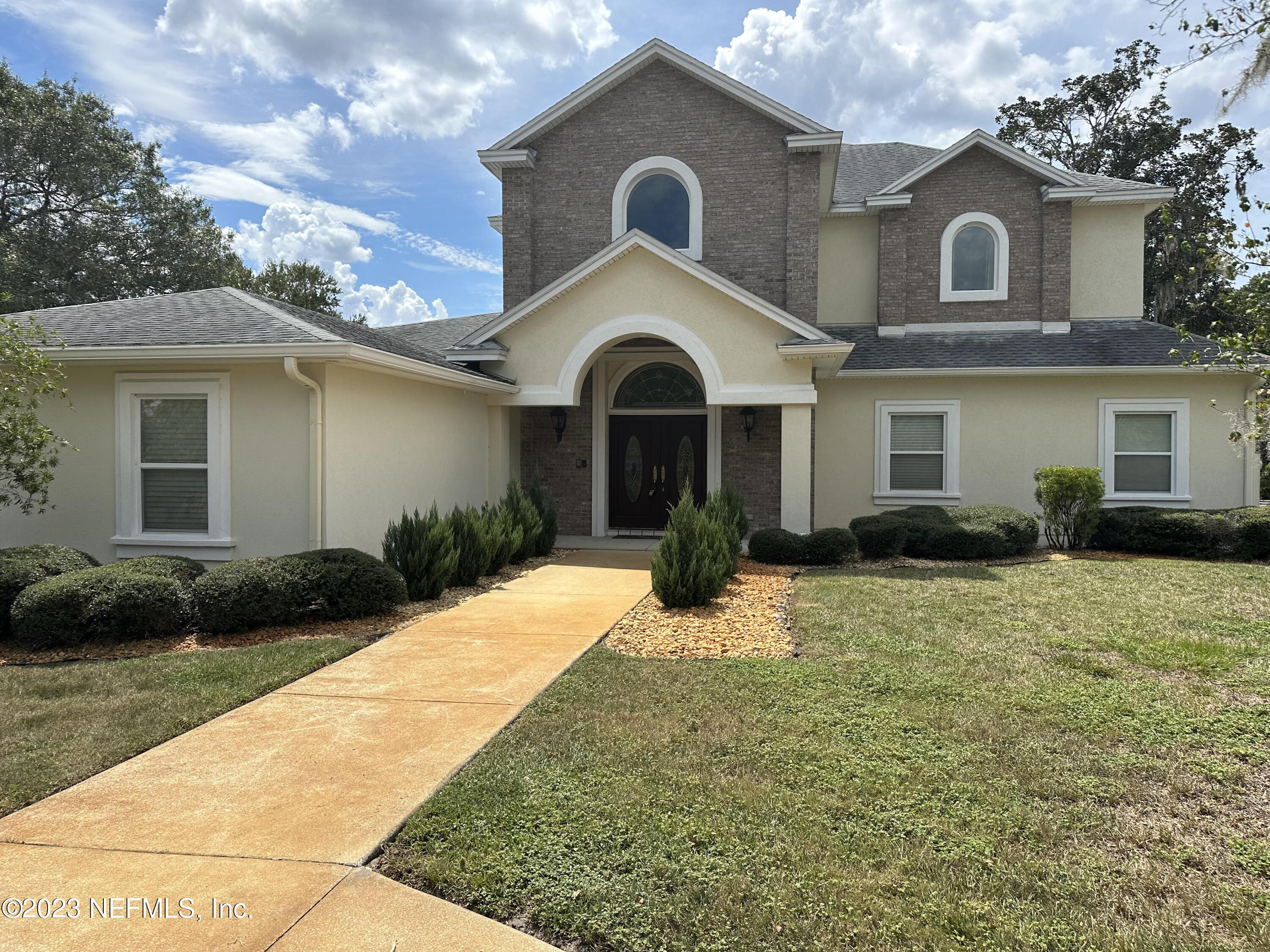 7936 Pine Lake Road Jacksonville, FL 32256 - Photo 2 of 52 a front view of a house with a yard