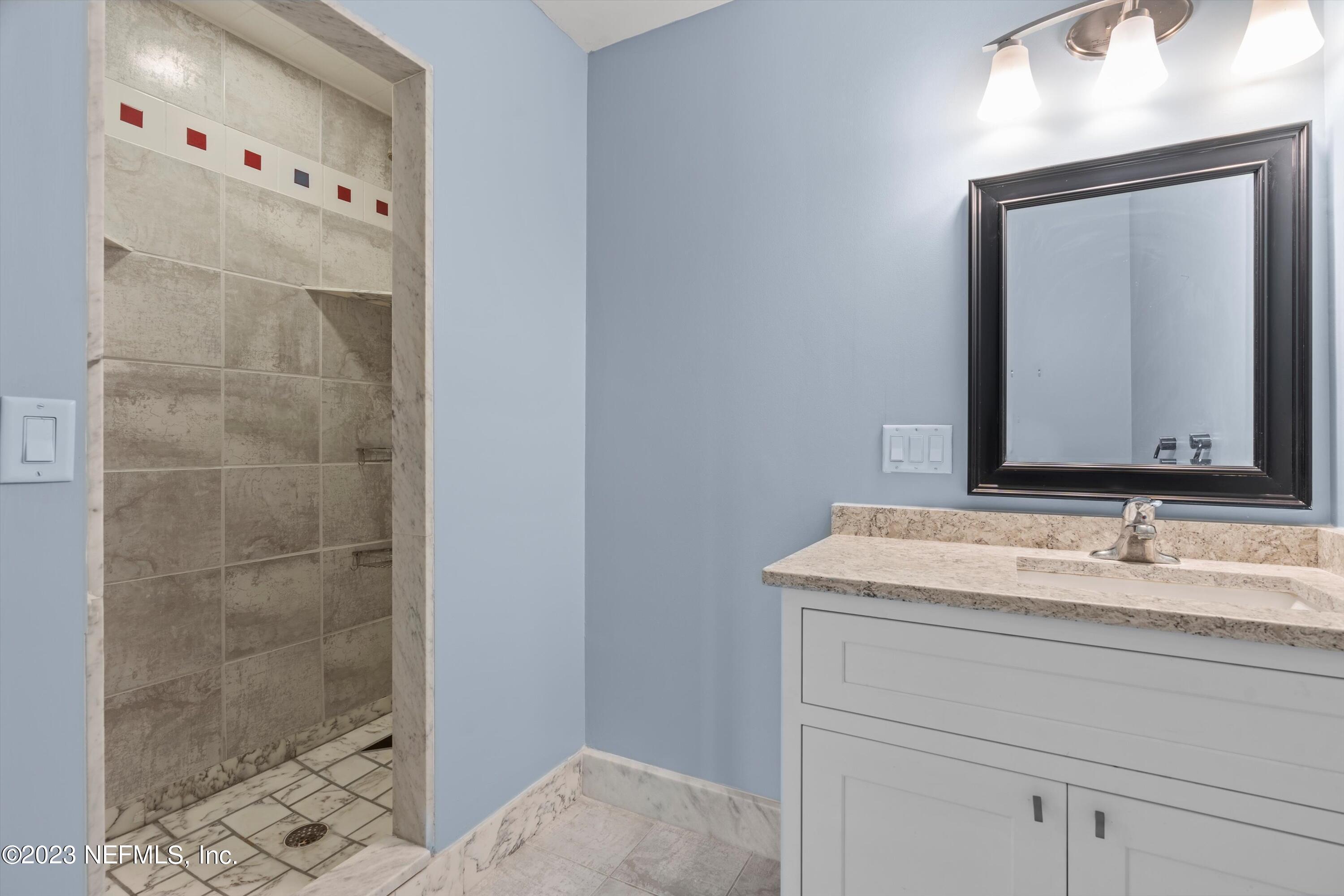 7936 Pine Lake Road Jacksonville, FL 32256 - Photo 21 of 52 a bathroom with a sink and a mirror